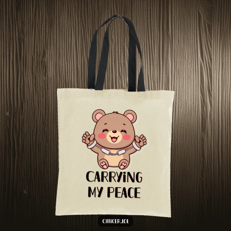 Funny tote bag featuring a cheerful bear in miniature handcuffs, smiling and waving, symbolizing adorable crime.